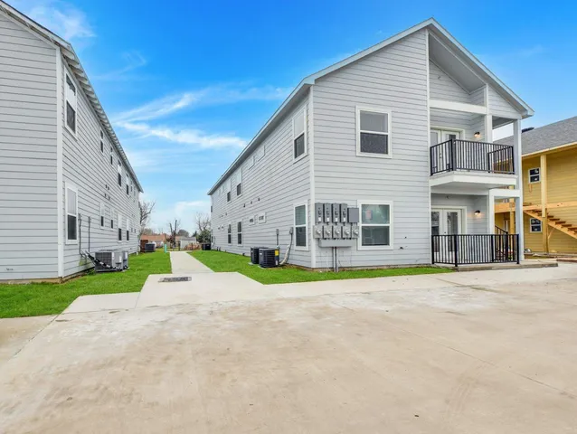 a view of a house with a yard and plants