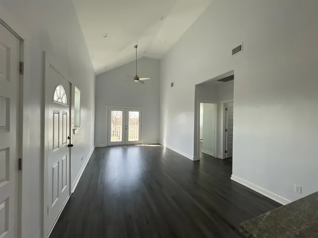 a view of a hallway with wooden floor