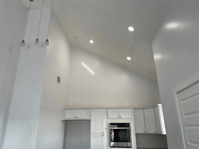 a view of kitchen with microwave and cabinets