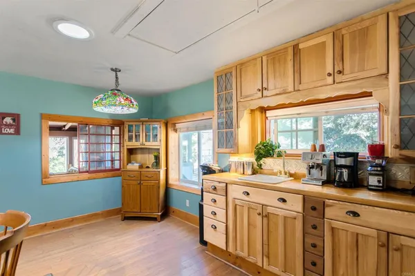 a view of a kitchen with a refrigerator and a sink