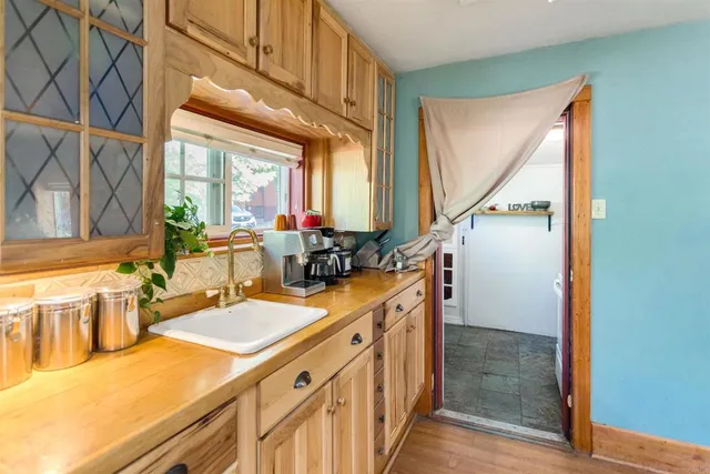 a kitchen with a refrigerator a stove top oven