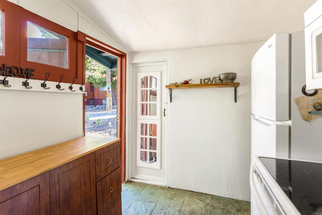 32787 Birch Hill Road Palomar Mountain, CA 92060 - Photo 19 of 44 a view of a kitchen with a refrigerator and a sink