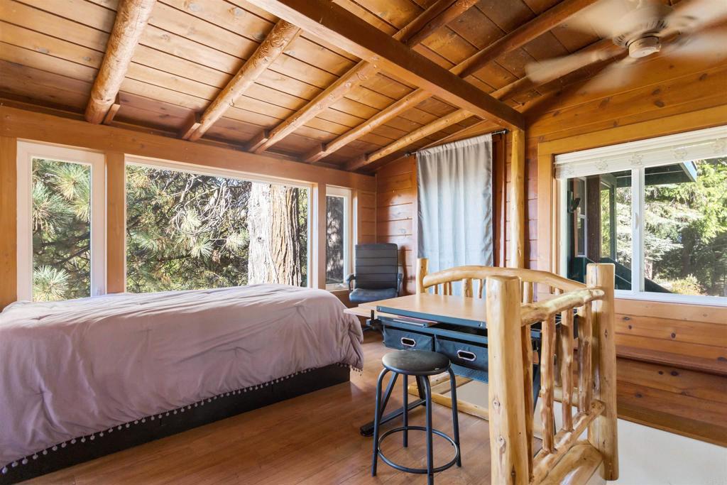 32787 Birch Hill Road Palomar Mountain, CA 92060 - Photo 23 of 44 a bed sitting in a spacious bedroom next to a window