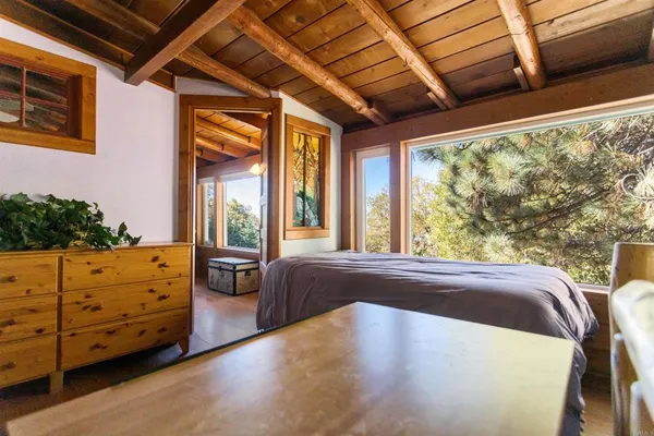 a bedroom with furniture and large window