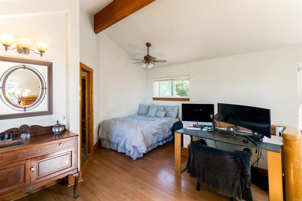 32787 Birch Hill Road Palomar Mountain, CA 92060 - Photo 30 of 44 a bedroom with a bed and a chandelier