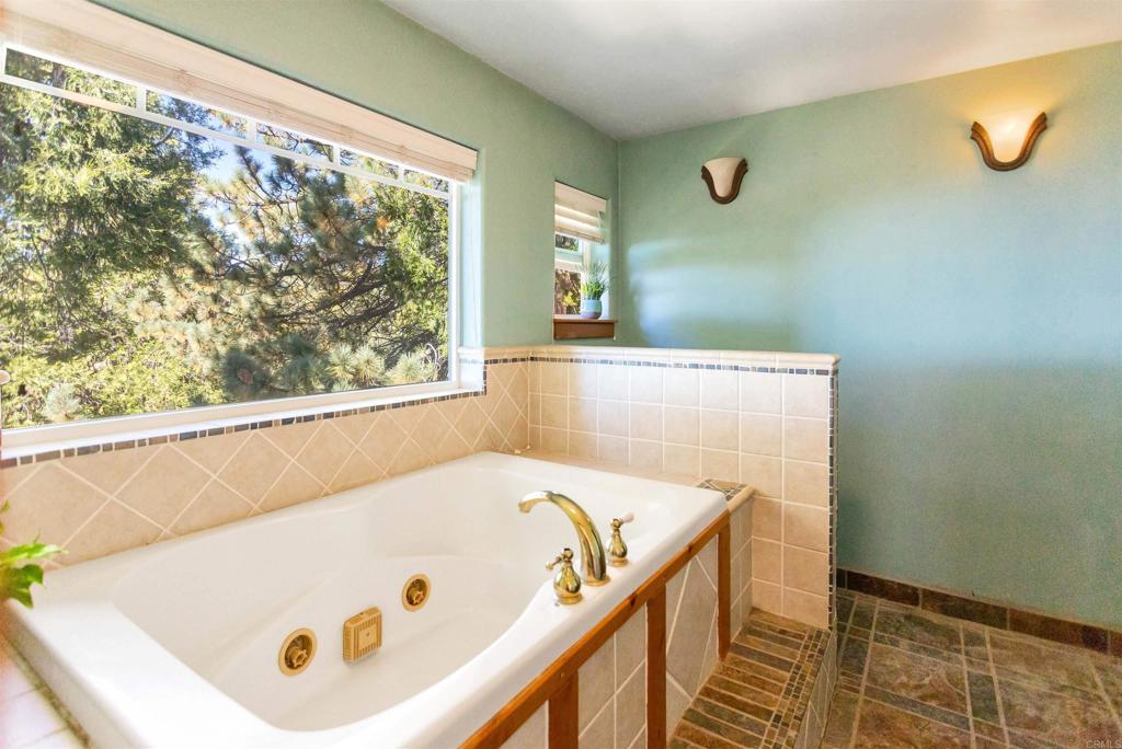 32787 Birch Hill Road Palomar Mountain, CA 92060 - Photo 31 of 44 a bathroom with a tub and glass window