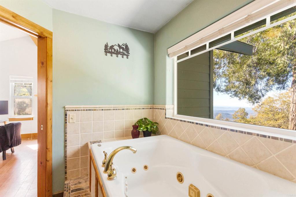 32787 Birch Hill Road Palomar Mountain, CA 92060 - Photo 32 of 44 a white bath tub sitting in a bathroom next to a window