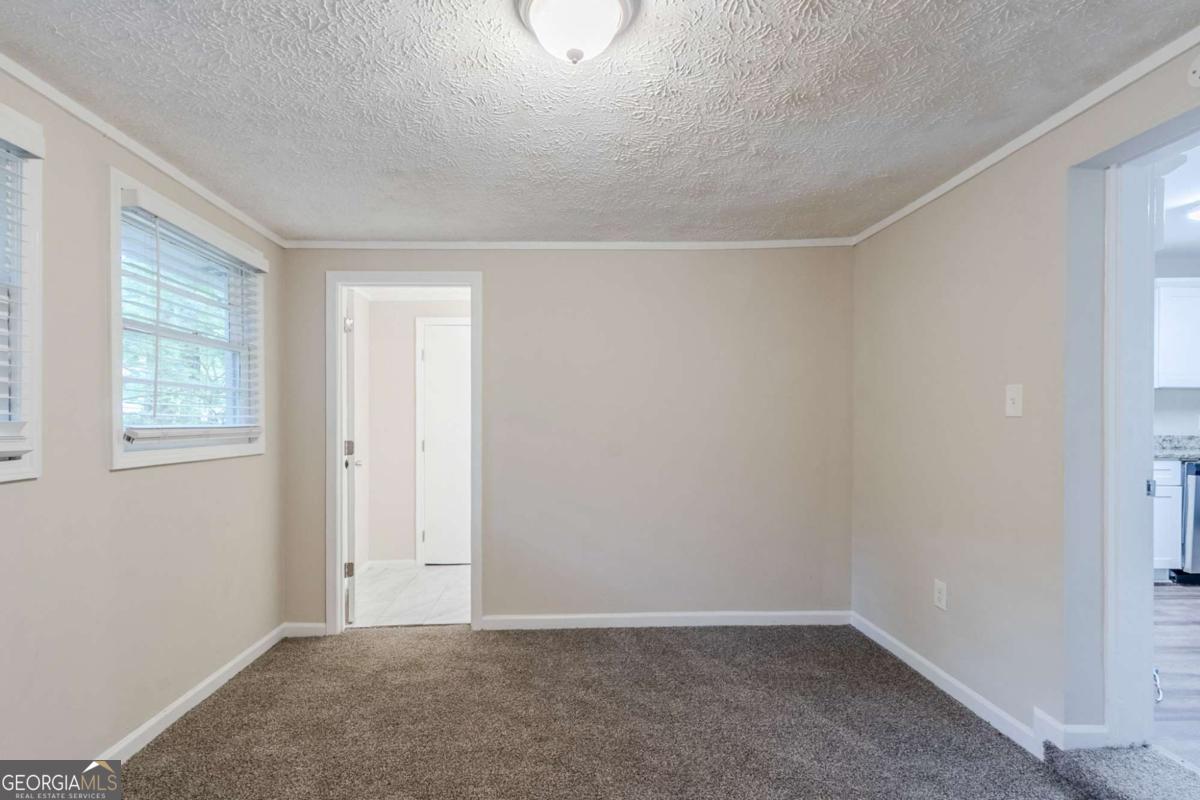 1715 Lee Street Decatur, GA 30035 - Photo 12 of 25 a view of an empty room with a window
