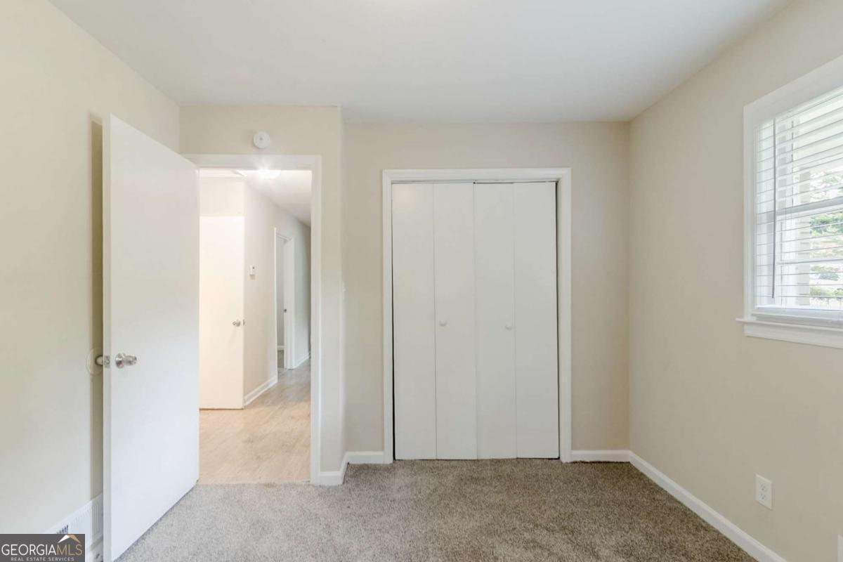 1715 Lee Street Decatur, GA 30035 - Photo 14 of 25 an empty room with windows and closet