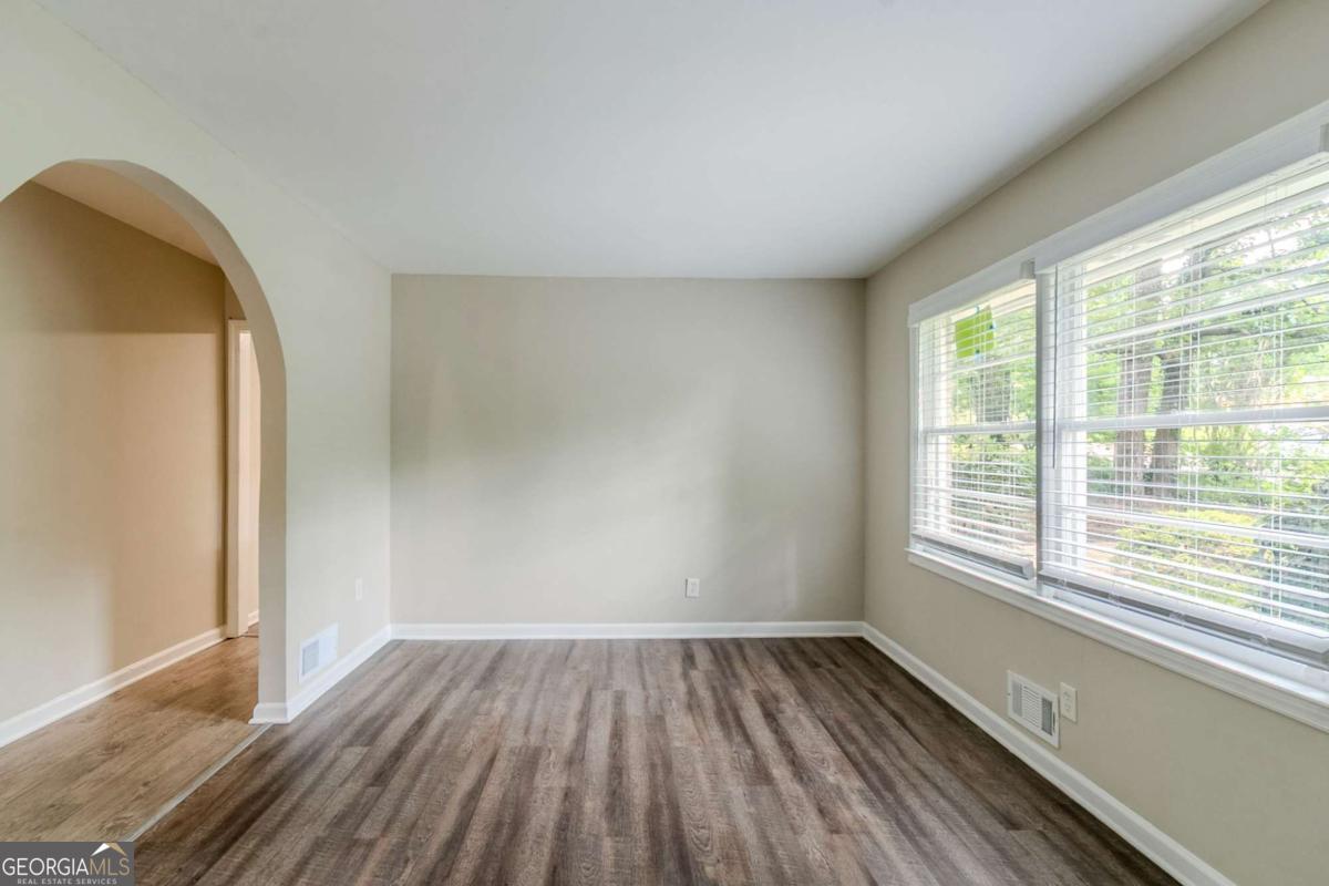 1715 Lee Street Decatur, GA 30035 - Photo 3 of 25 an empty room with wooden floor and windows