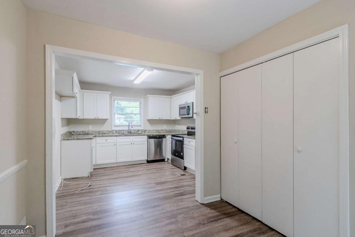 1715 Lee Street Decatur, GA 30035 - Photo 10 of 25 a kitchen with a refrigerator sink and cabinets