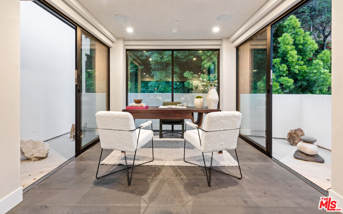 9455 Readcrest Drive Beverly Hills, CA 90210 - Photo 24 of 40 a dining room with furniture and floor to ceiling windows