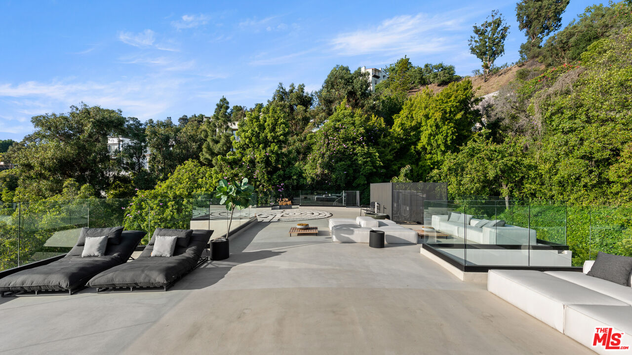 9455 Readcrest Drive Beverly Hills, CA 90210 - Photo 28 of 40 a view of a patio with couches and a fire pit