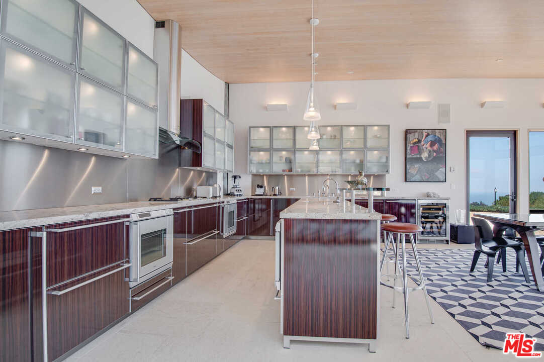 350 Ortega Ridge Road Montecito, CA 93108 - Photo 18 of 39 a large kitchen with stainless steel appliances granite countertop a stove and a refrigerator