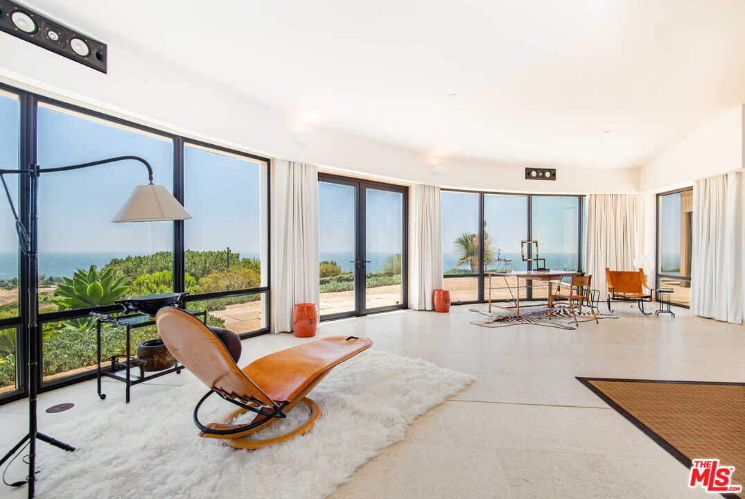 350 Ortega Ridge Road Montecito, CA 93108 - Photo 22 of 39 a living room with furniture and floor to ceiling window