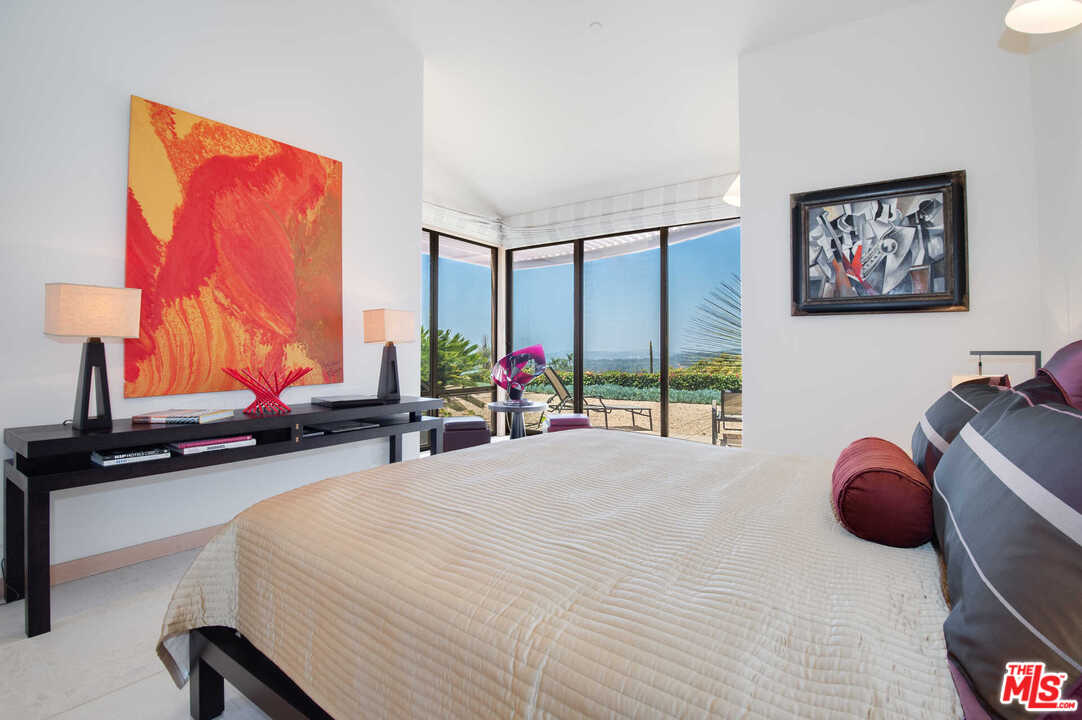 350 Ortega Ridge Road Montecito, CA 93108 - Photo 24 of 39 a bedroom with furniture and a large window