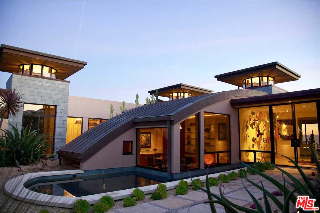 350 Ortega Ridge Road Montecito, CA 93108 - Photo 5 of 39 a front view of a house with garden and patio