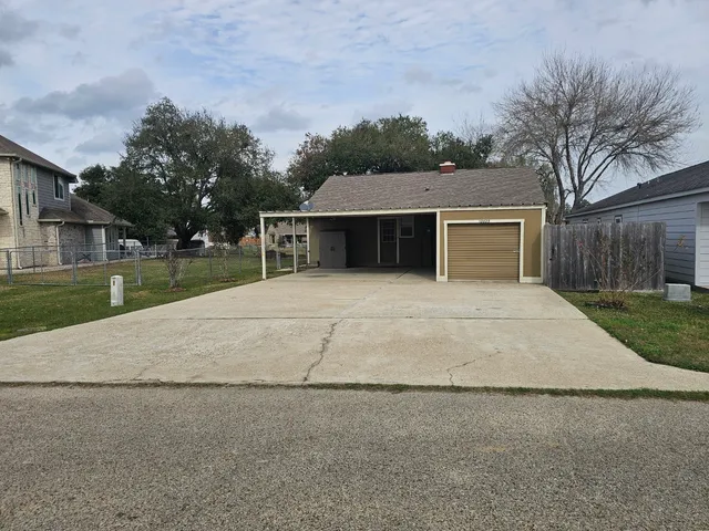 a view of house with yard and a garage