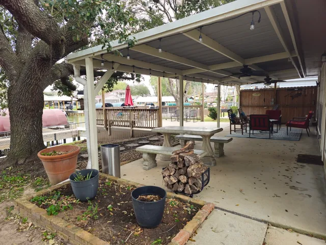 a view of a patio with table and chairs potted plants