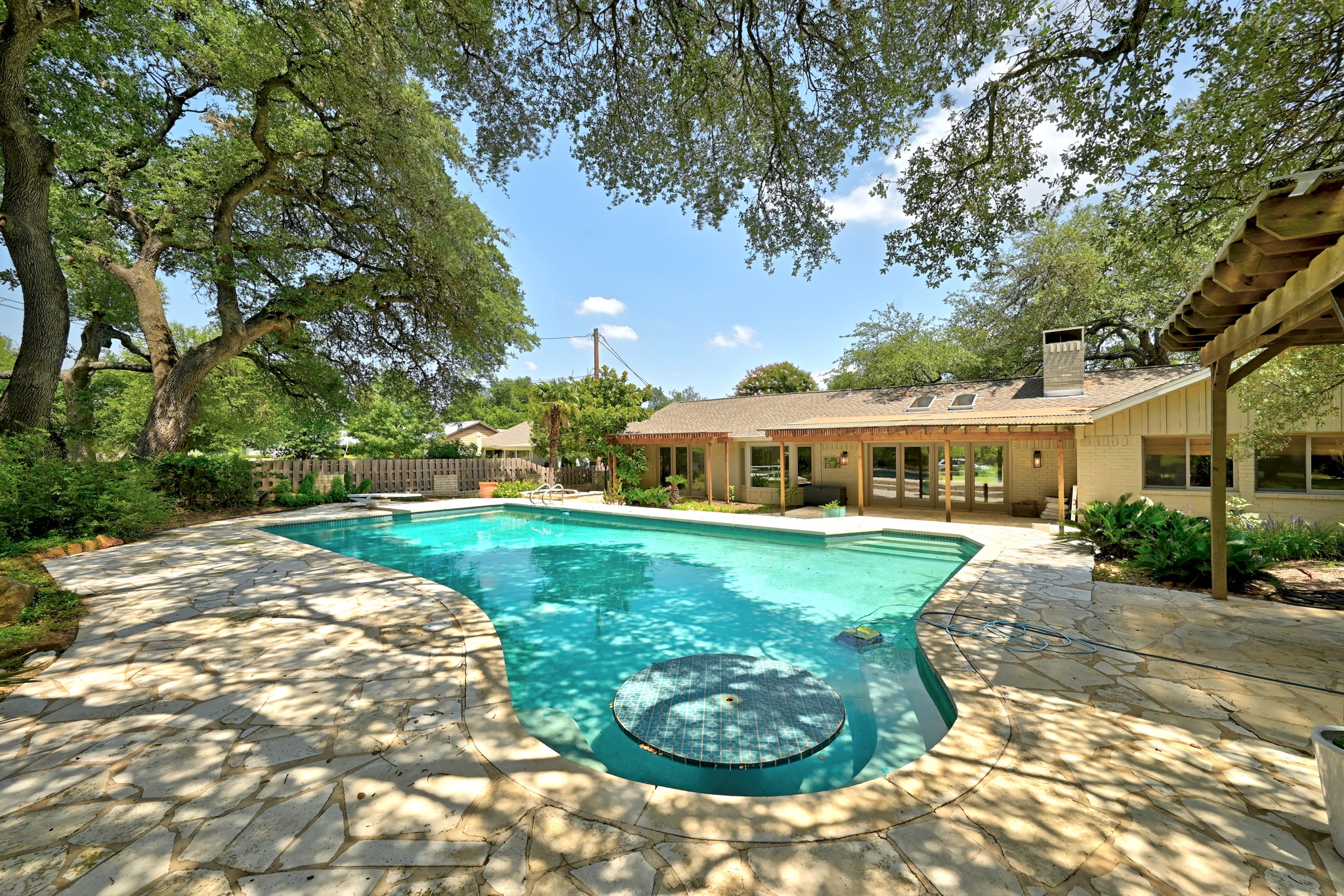8608 Crest Ridge Circle Austin, TX 78750 - Photo 29 of 38 A spacious backyard oasis features a free-form pool surrounded by flagstone paving and mature trees.