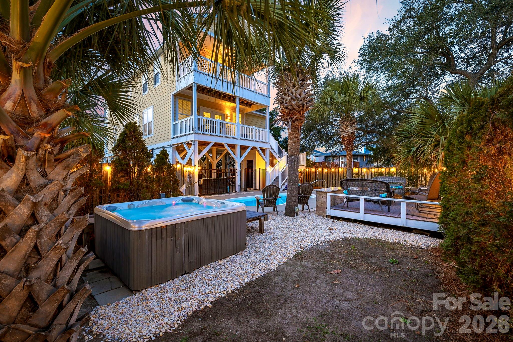 a view of a house with swimming pool and sitting area