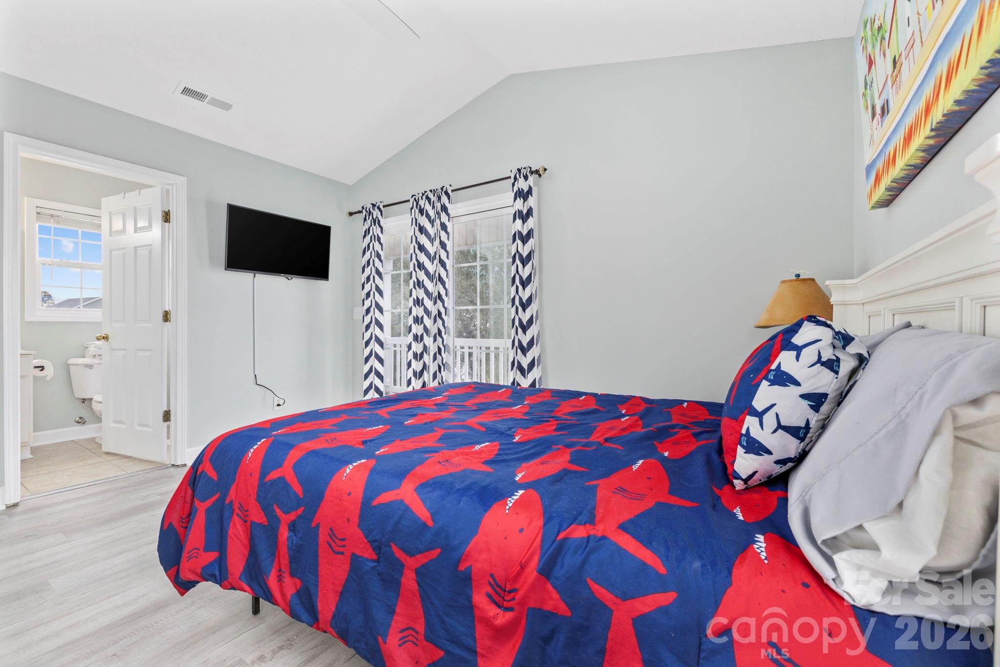 122 Rainbow Drive Murrells Inlet, SC 29576 - Photo 27 of 39 a bedroom with a bed and a tv