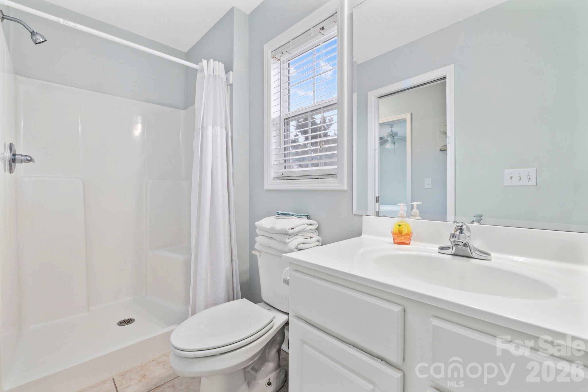 122 Rainbow Drive Murrells Inlet, SC 29576 - Photo 29 of 39 a bathroom with a sink a toilet and shower