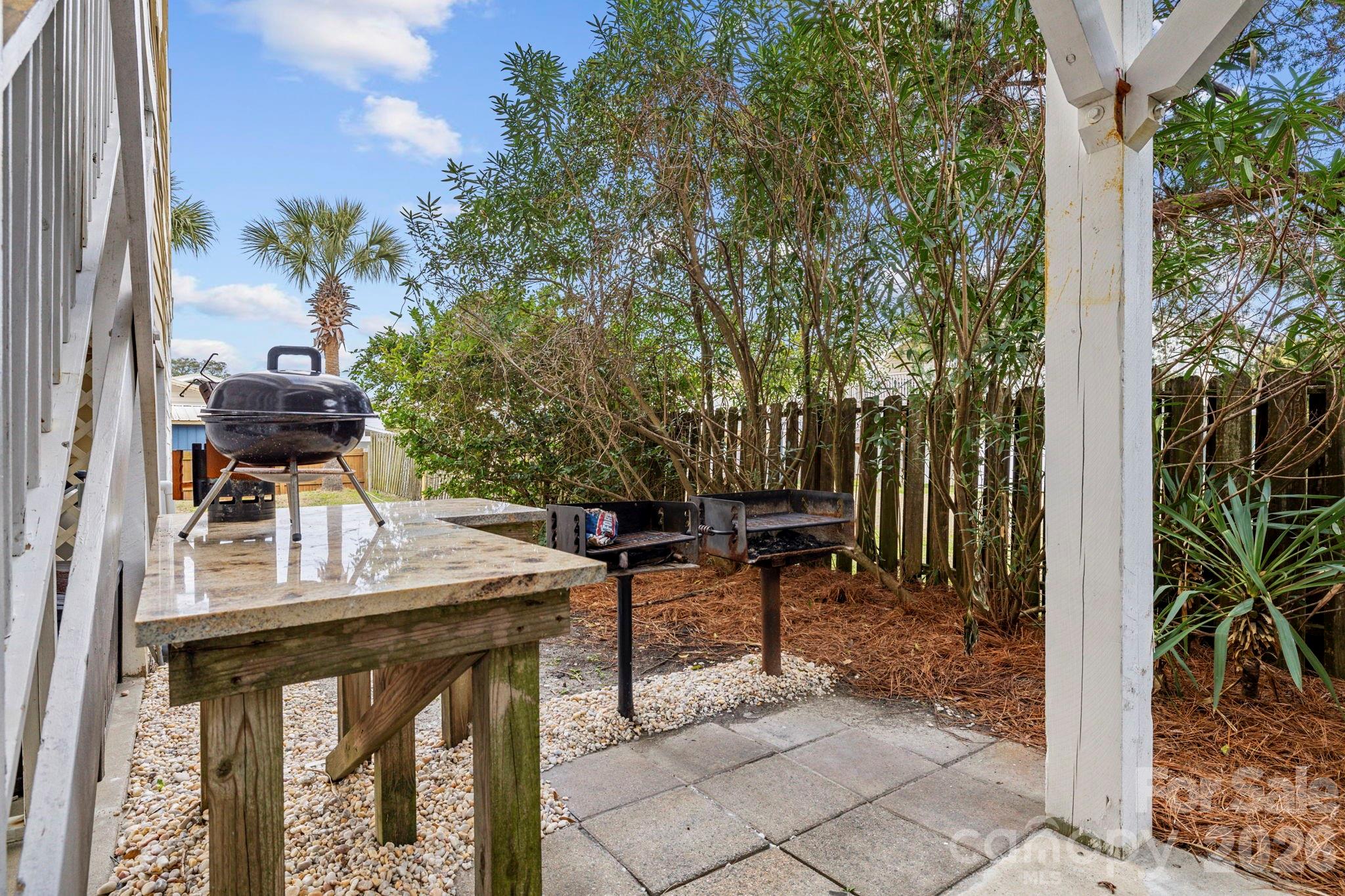 122 Rainbow Drive Murrells Inlet, SC 29576 - Photo 7 of 39 a backyard of a house with table and chairs