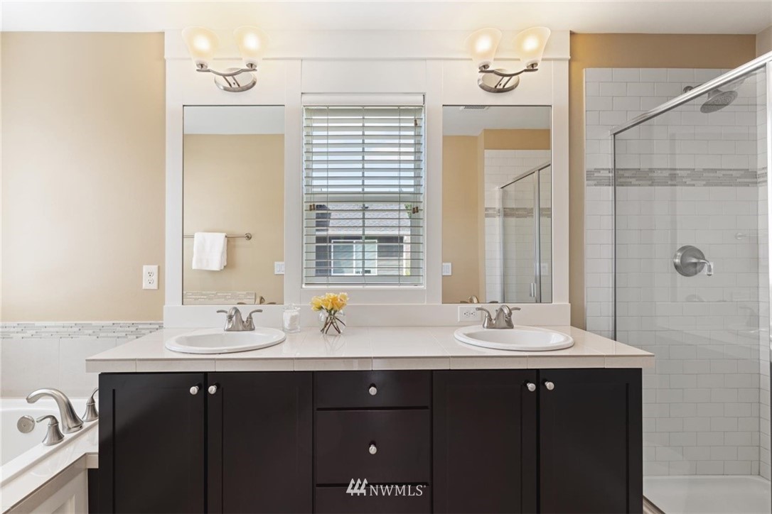 21909 38th Drive Southeast Bothell, WA 98021 - Photo 22 of 37 a bathroom with a double vanity sink a mirror and a window