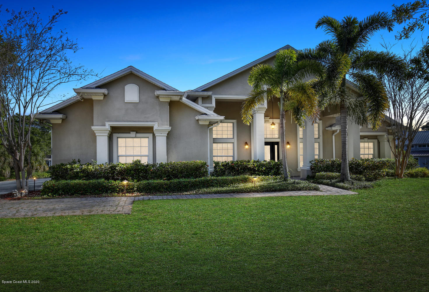 3960 Crooked Mile Road Merritt Island, FL 32952 - Photo 2 of 42 a front view of a house with a yard and garage
