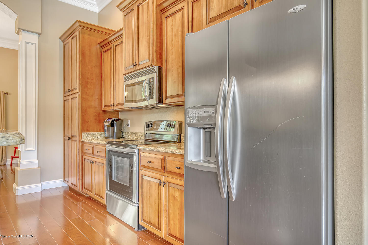 3960 Crooked Mile Road Merritt Island, FL 32952 - Photo 15 of 42 a kitchen with stainless steel appliances granite countertop a refrigerator and a stove