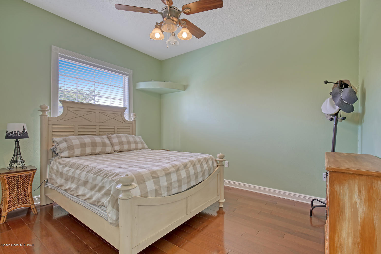 3960 Crooked Mile Road Merritt Island, FL 32952 - Photo 21 of 42 a bedroom with a bed chandelier and a window