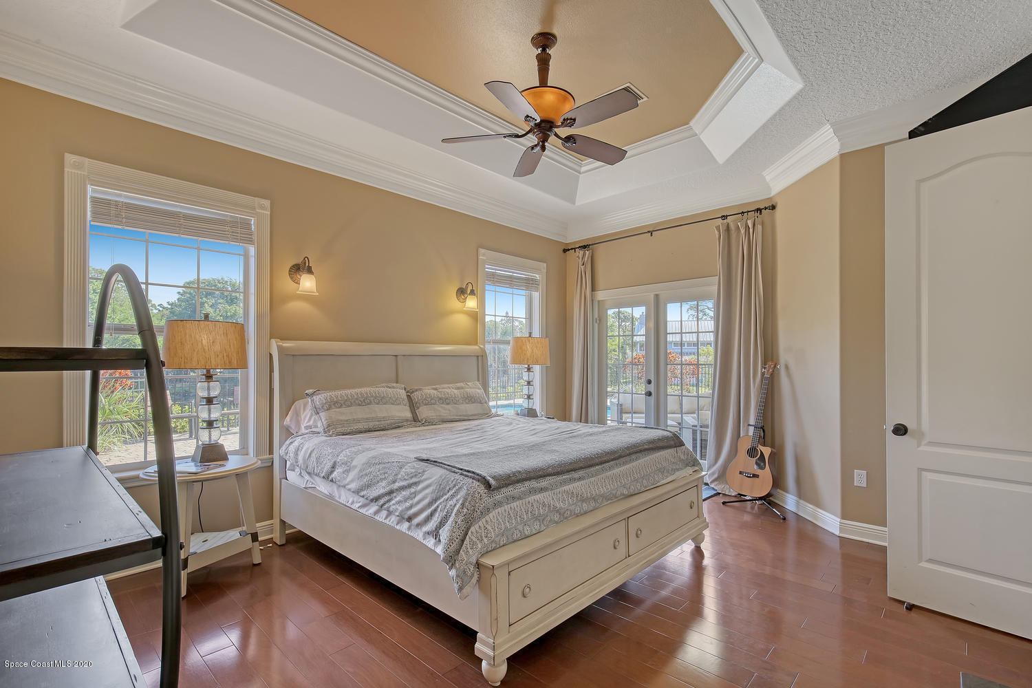 3960 Crooked Mile Road Merritt Island, FL 32952 - Photo 24 of 42 a bedroom with a bed and a chandelier