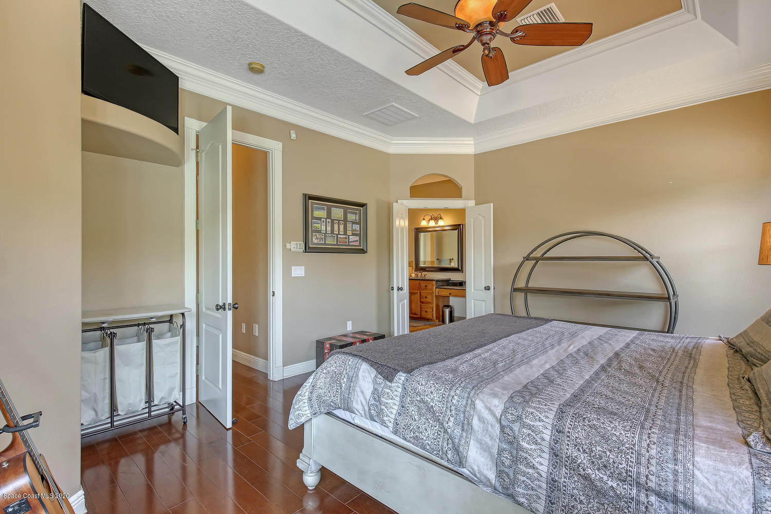 3960 Crooked Mile Road Merritt Island, FL 32952 - Photo 26 of 42 a bedroom with a bed and a chandelier