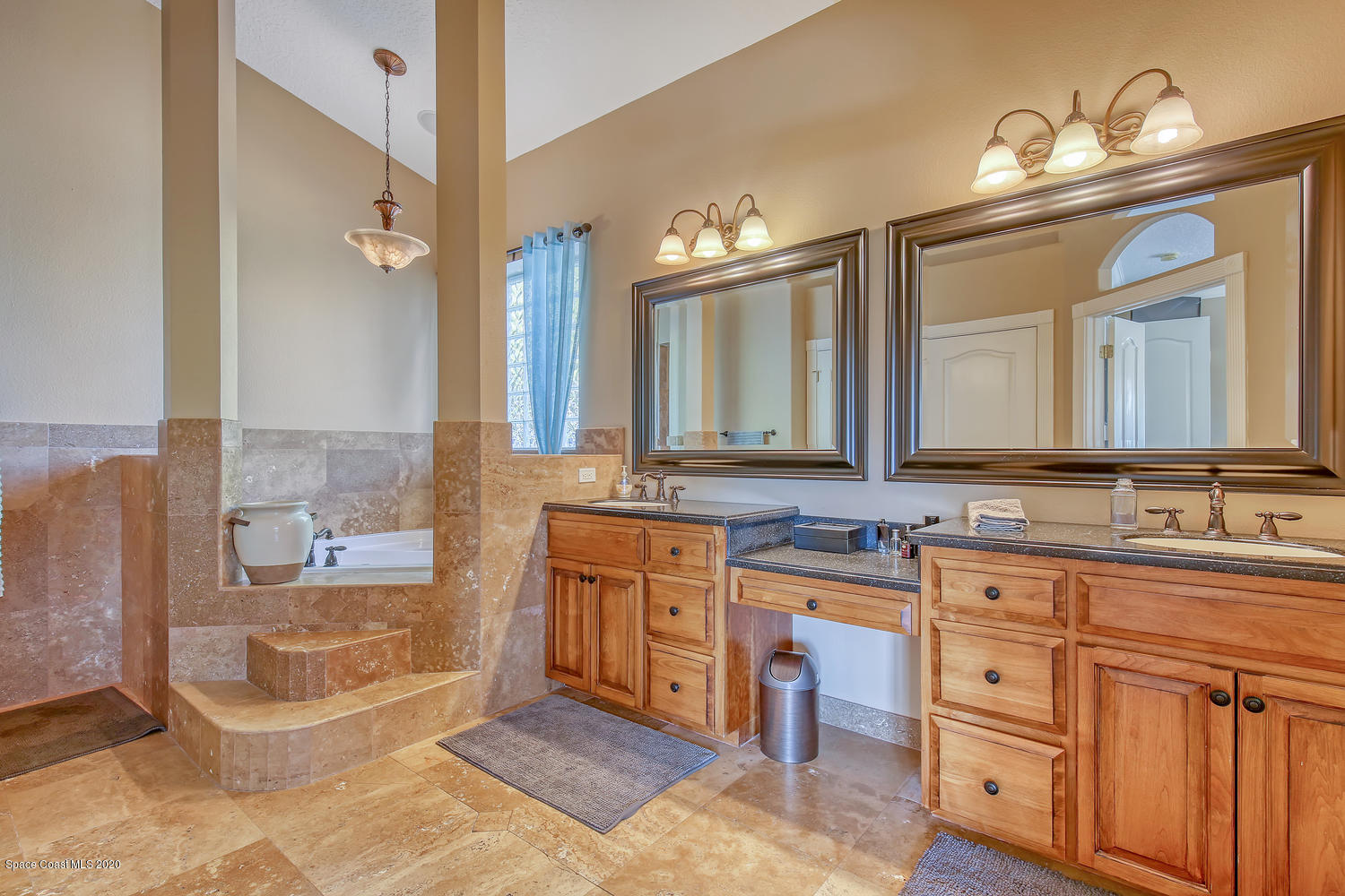 3960 Crooked Mile Road Merritt Island, FL 32952 - Photo 27 of 42 a spacious bathroom with a double vanity sink a large mirror and a bathtub