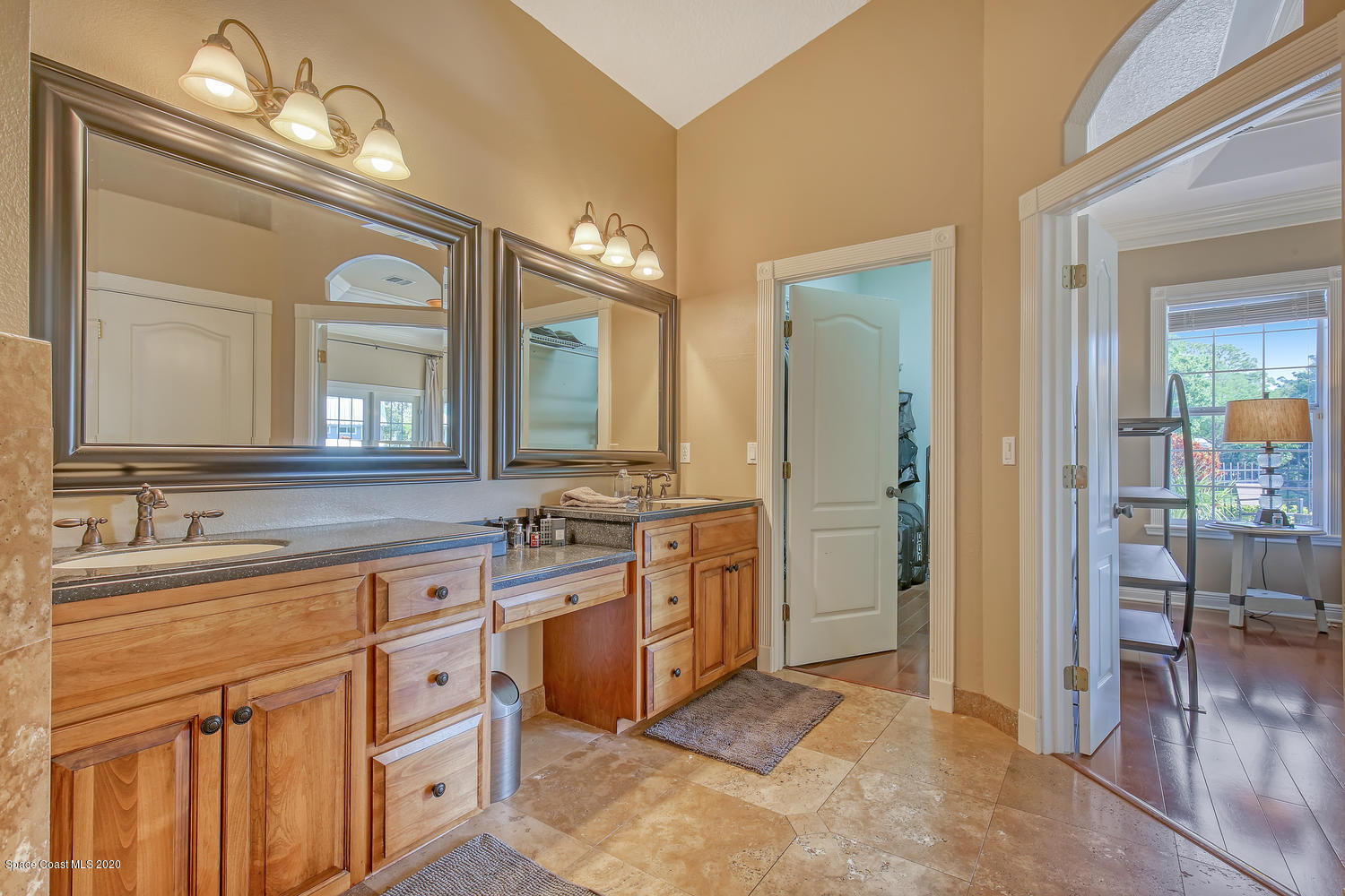 3960 Crooked Mile Road Merritt Island, FL 32952 - Photo 29 of 42 a spacious bathroom with a granite countertop sink a mirror and a shower