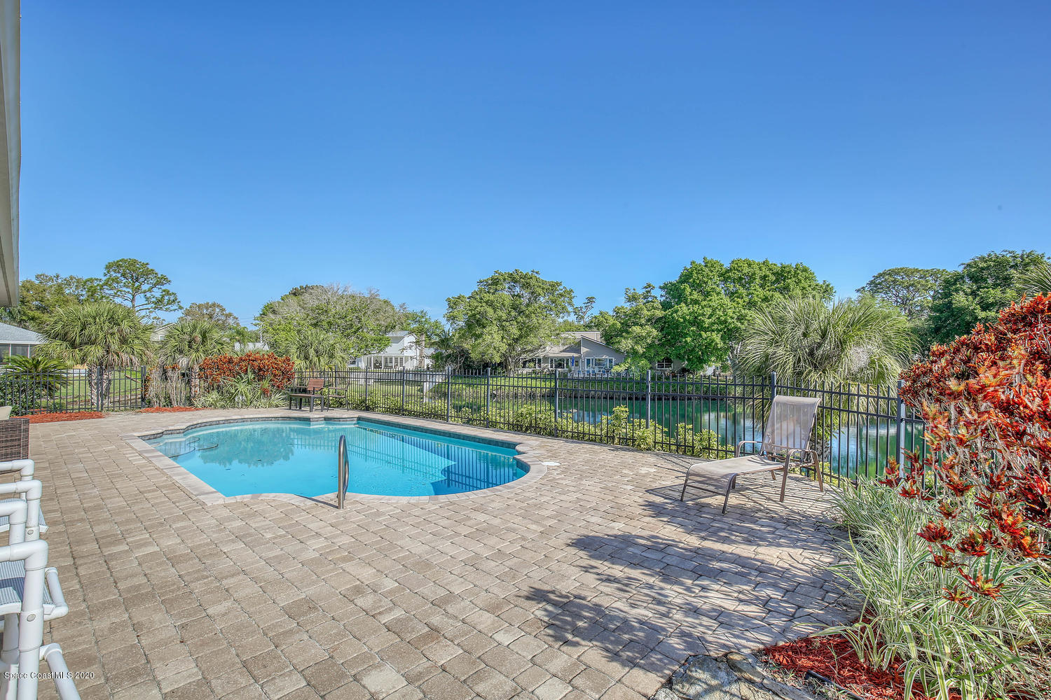 3960 Crooked Mile Road Merritt Island, FL 32952 - Photo 32 of 42 a view of a swimming pool with a yard and lake view