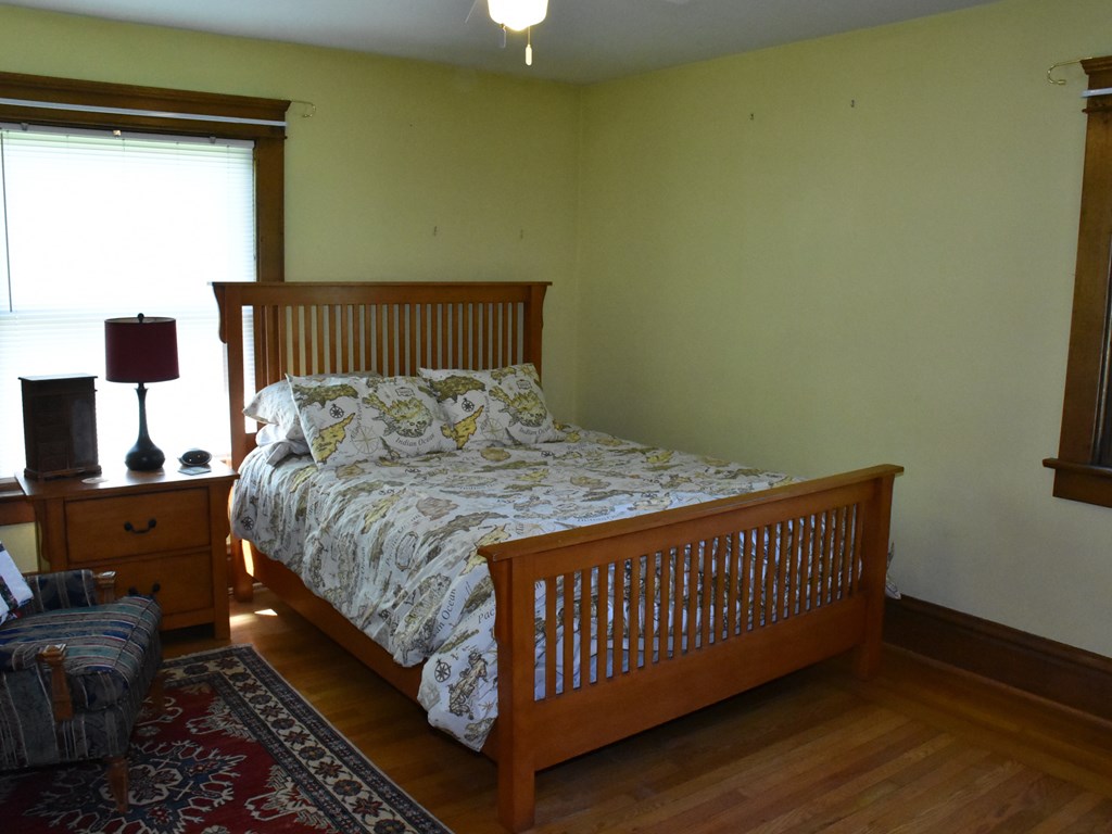 655 Chestnut Street Meadville, PA 16335 - Photo 26 of 43 a bedroom with a bed and wooden floor
