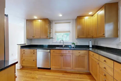 a kitchen with stainless steel appliances granite countertop a sink and cabinets