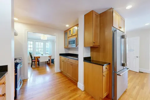 a view of living room with furniture and wooden floor