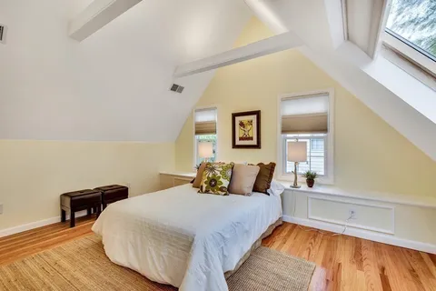 a bedroom with a bed and a night stand