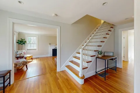 a view of a livingroom with furniture and staircase