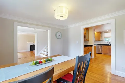 a dining room with furniture and wooden floor