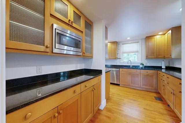 a kitchen with stainless steel appliances granite countertop a sink and cabinets