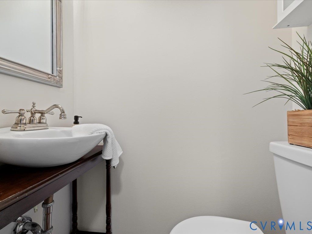 9107 Derbyshire Road, Unit J Henrico, VA 23229 - Photo 19 of 38 a bathroom with a sink a toilet and a mirror