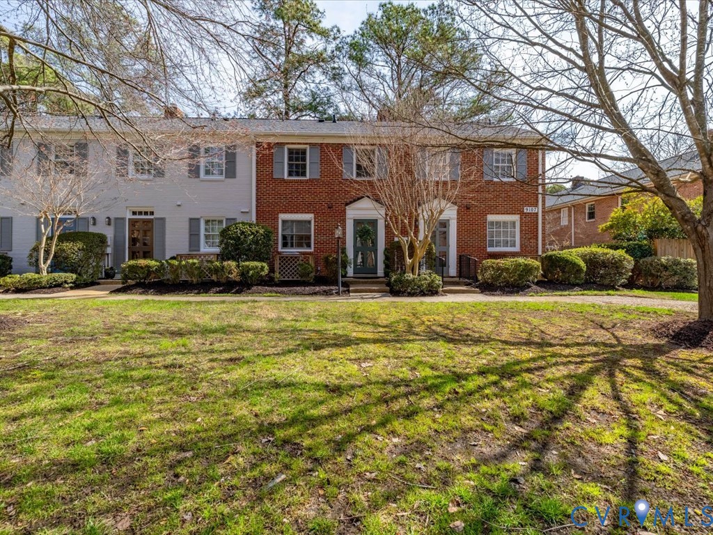 9107 Derbyshire Road, Unit J Henrico, VA 23229 - Photo 2 of 38 a front view of house with yard and trees around