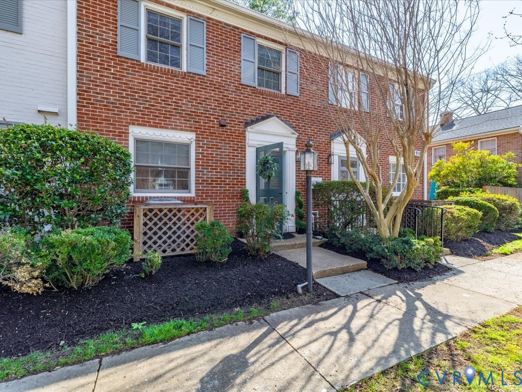 9107 Derbyshire Road, Unit J Henrico, VA 23229 - Photo 29 of 38 a view of a brick house with yard and plants