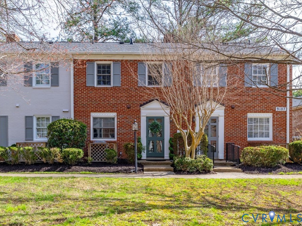 9107 Derbyshire Road, Unit J Henrico, VA 23229 - Photo 3 of 38 a front view of a house with a yard