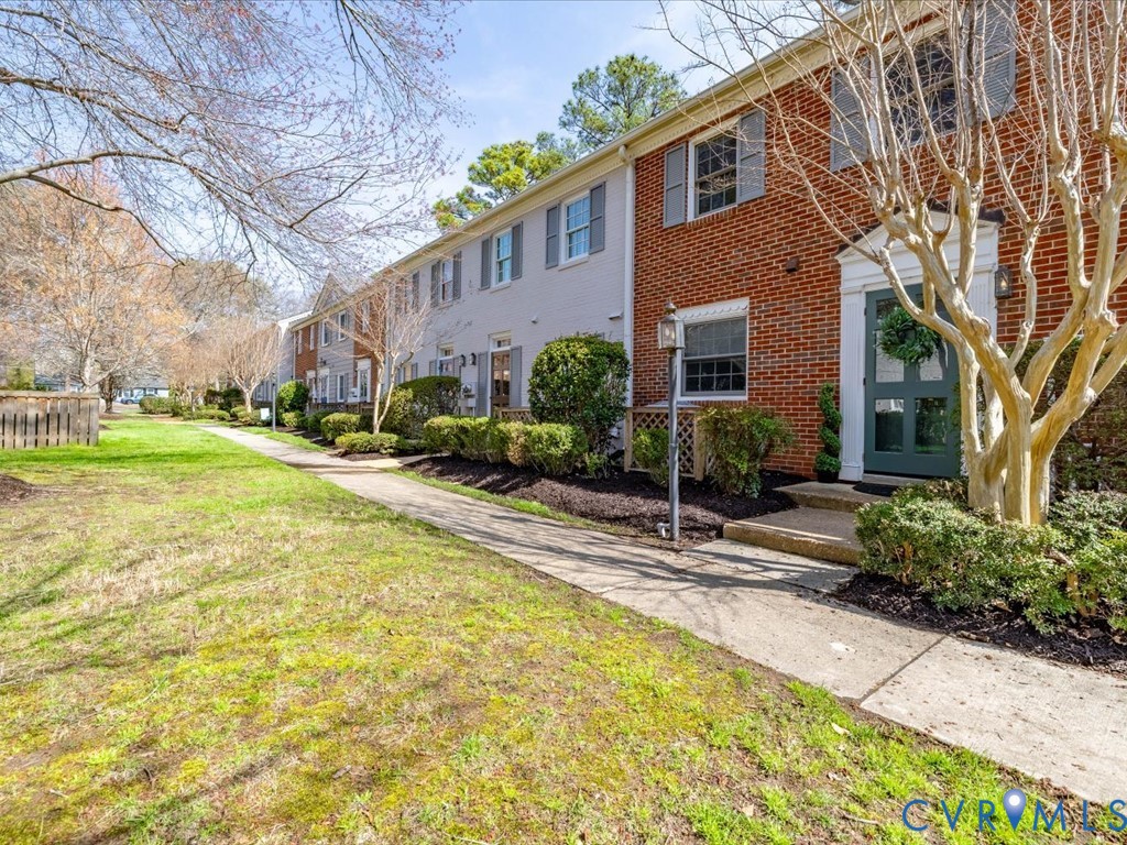 9107 Derbyshire Road, Unit J Henrico, VA 23229 - Photo 31 of 38 a view of a building with a yard and plants