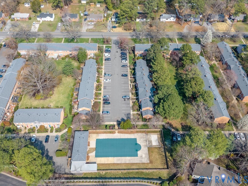 9107 Derbyshire Road, Unit J Henrico, VA 23229 - Photo 35 of 38 an aerial view of a residential apartment building with a yard and parking spaces